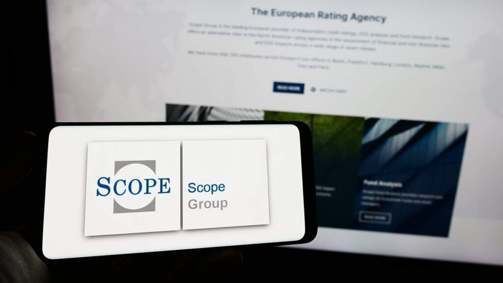 Scope Ratings logo seen on mobile device and its website on a computer screen shutterstock